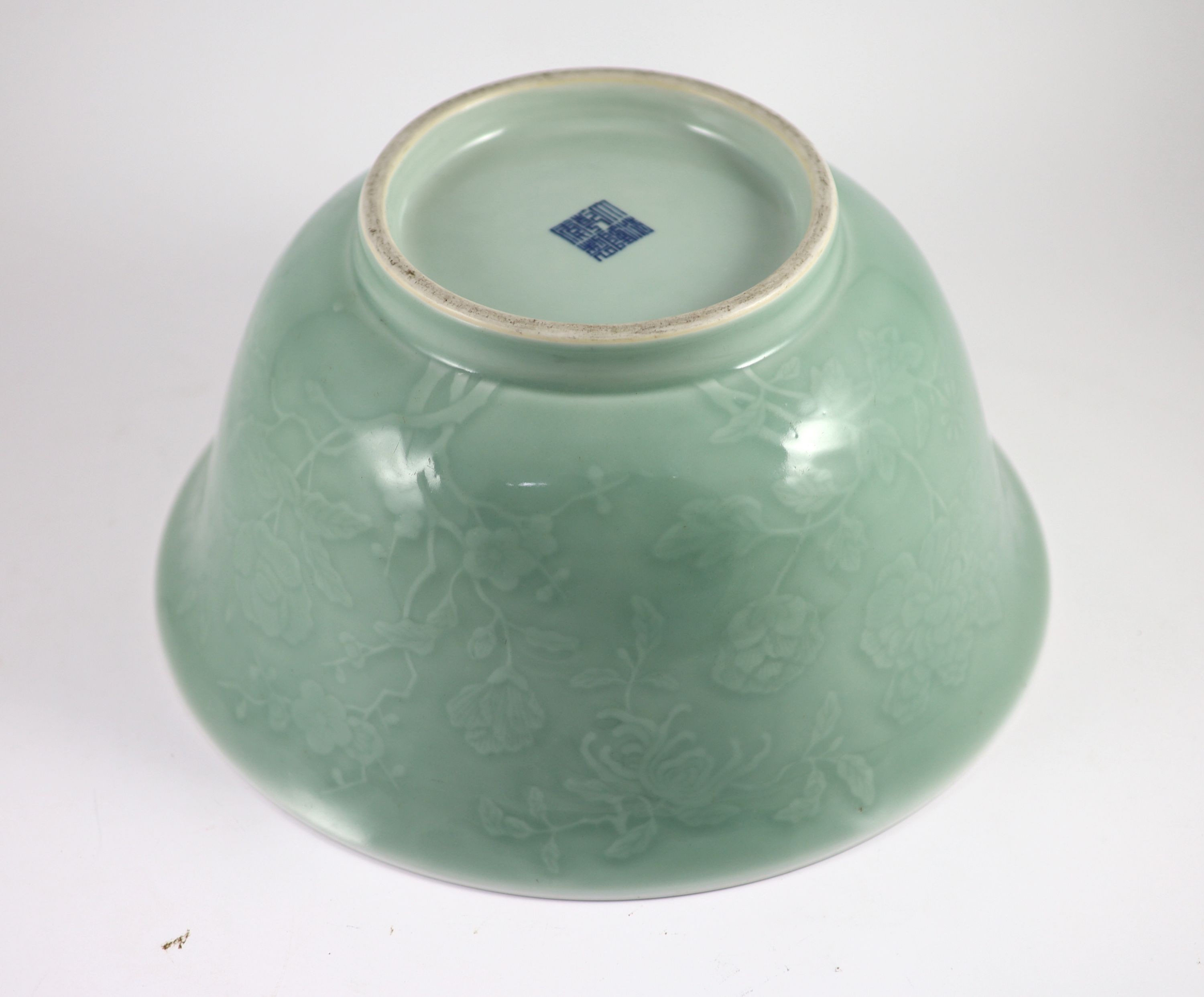 A fine large Chinese moulded celadon-glazed bowl, Qianlong seal mark and of the period (1736-95), Rim 33.6mm diameter, 16.5cm high, foot 16cm diameter